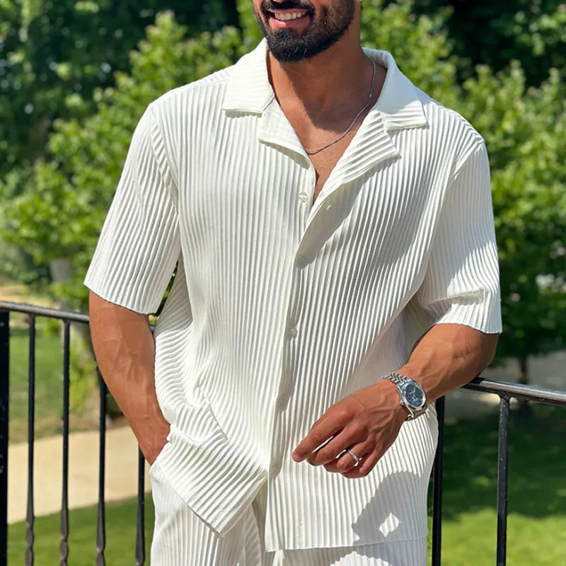 Coordinated men's pleated outfit set with short sleeve camp collar shirt & straight leg trousers for holidays.