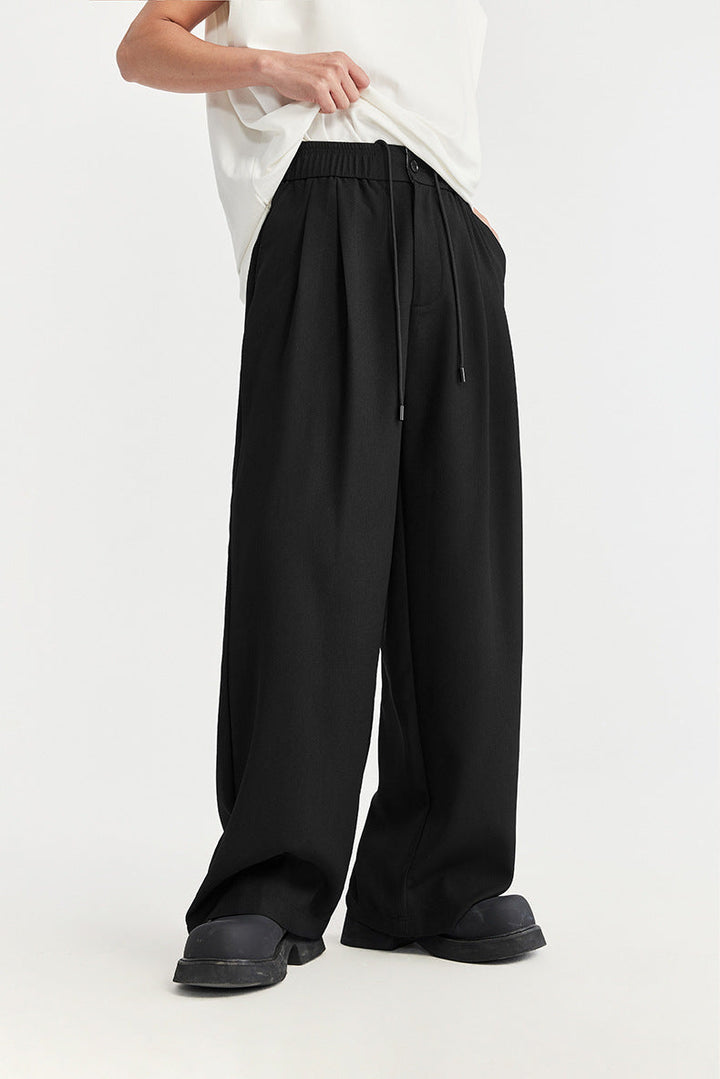 Stylish men's pleated wide leg trousers with drawstring. Modern, relaxed fit comfort for daily wear.
