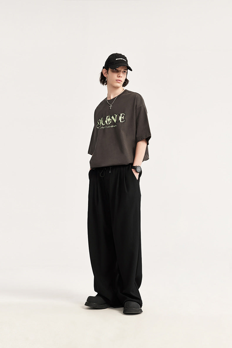 Modern men's wide leg drawstring pants, pleated for a relaxed, comfortable fit. Fashionable trousers.
