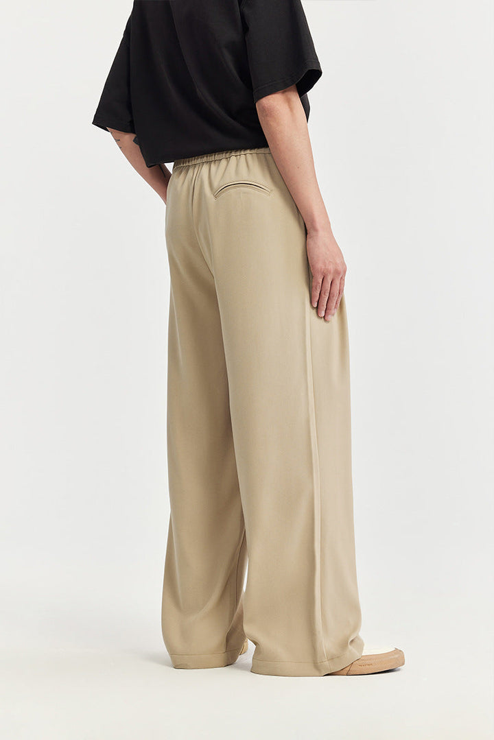 Fashionable men's wide leg pants with pleats & drawstring. Relaxed, modern fit for stylish comfort.