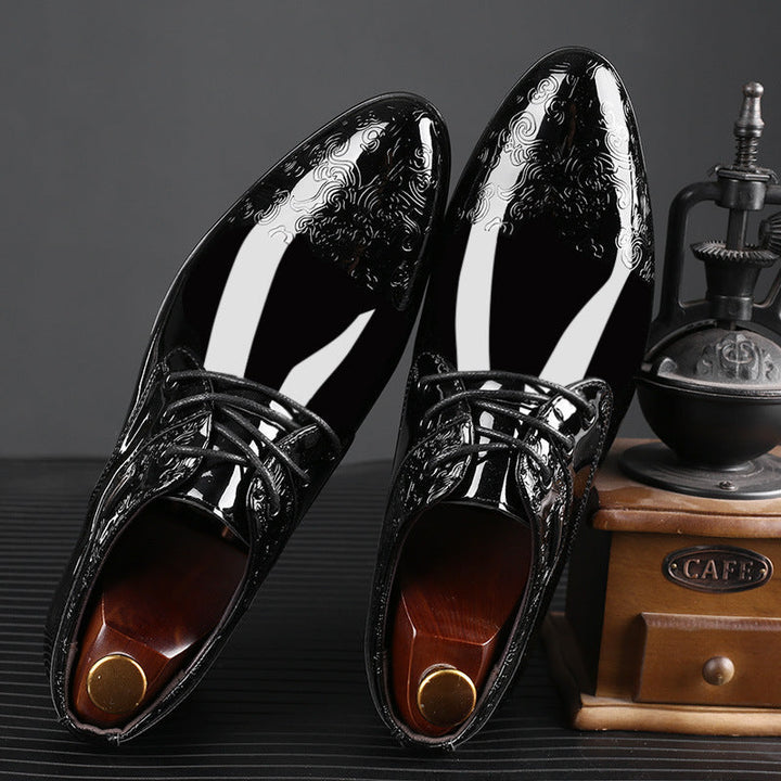 Shiny men's polished derby dress shoes in black, with elegant embossed texture and lace-up front, suitable for formal occasions.