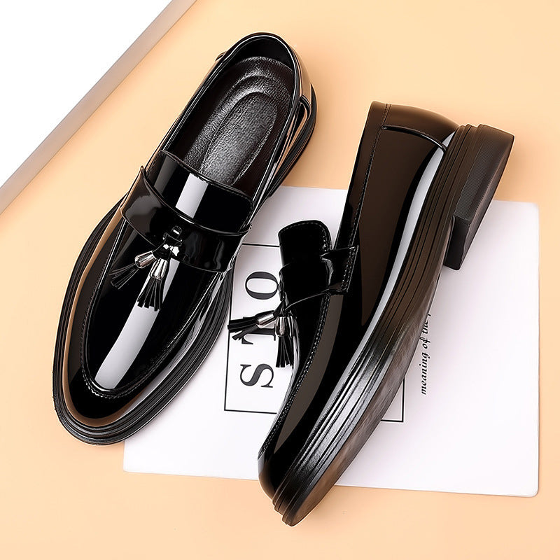 Classic men's polished black tassel penny loafers. Stylish slip-on dress shoes for a refined and versatile look.