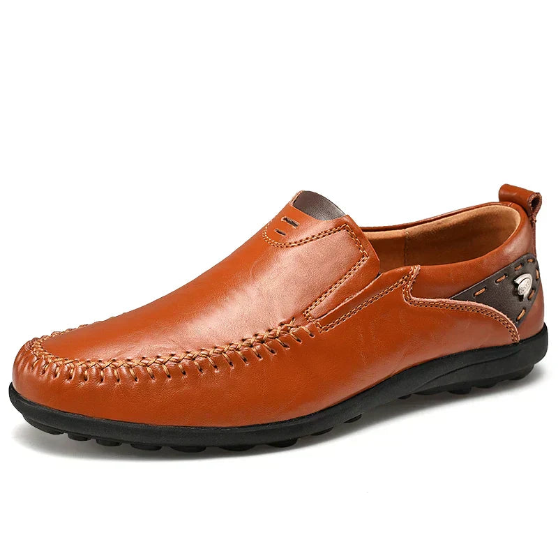 Close-up of men's premium suede loafers, showcasing soft texture & detailed stitching. Comfortable slip-on shoes.