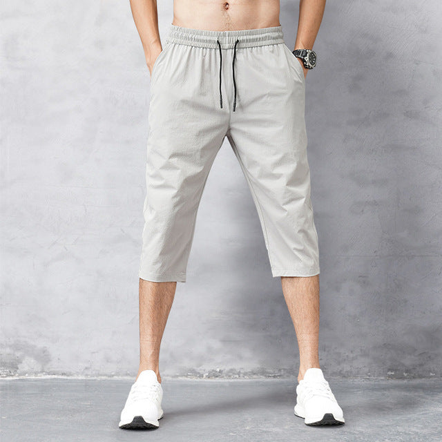 Men's quick-dry long swim shorts in blue, perfect for beach, pool, and casual summer wear. Comfortable & versatile.