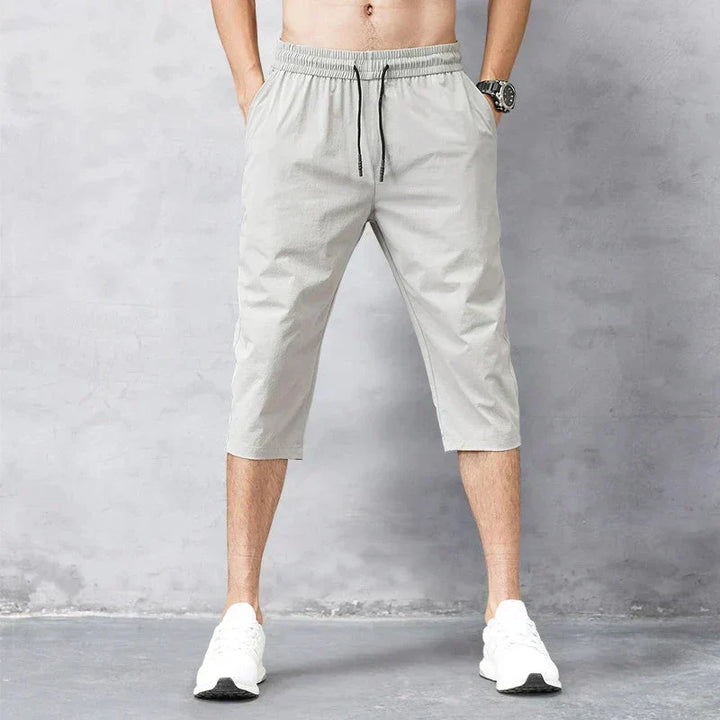 Athletic men's long quick-dry swim shorts for beach vacations or pool sports. Comfortable and stylish swimwear.