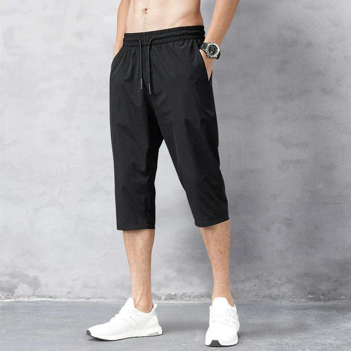 Versatile black men's long quick-dry swim shorts, ideal for beach, pool, or casual summer outings. Ultimate comfort.