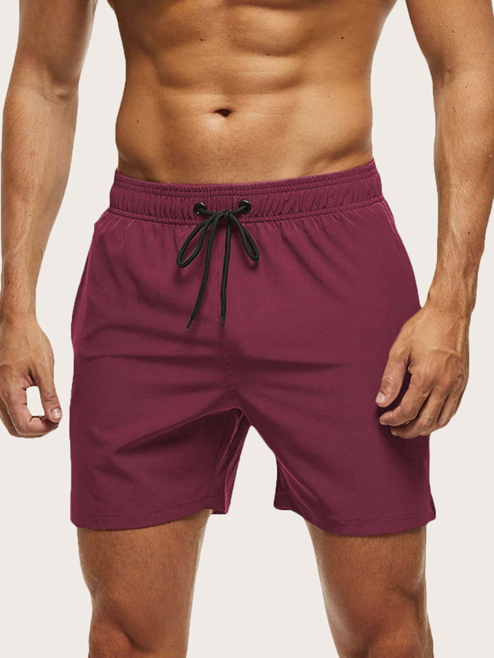 Athletic men's swim shorts, quick-dry fabric & flexible stretch. Essential beachwear for men.