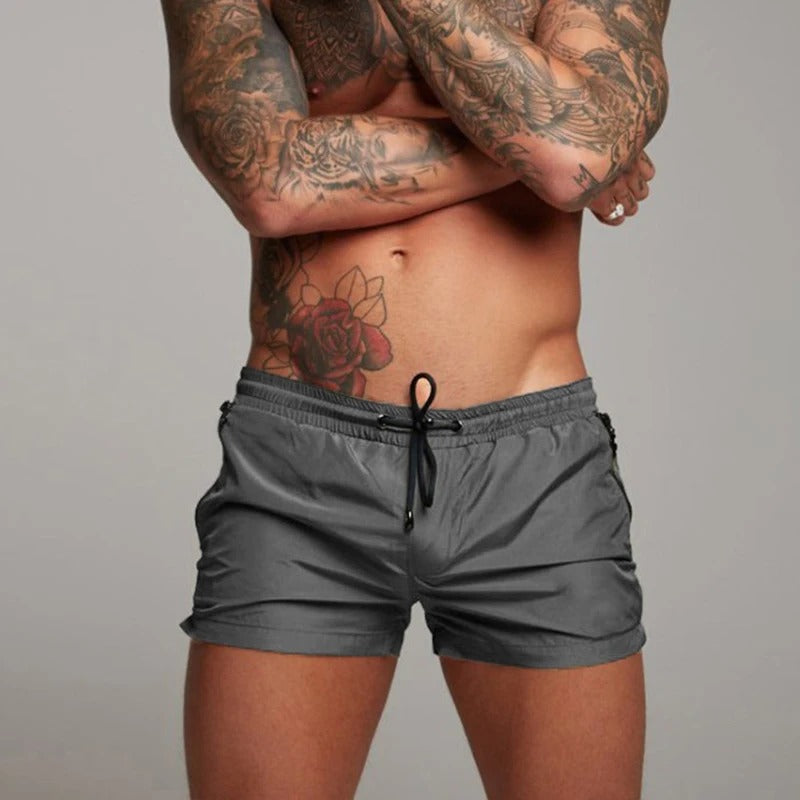 Quick-dry & stretch men's swim shorts featuring convenient pockets, ideal for summer beachwear.