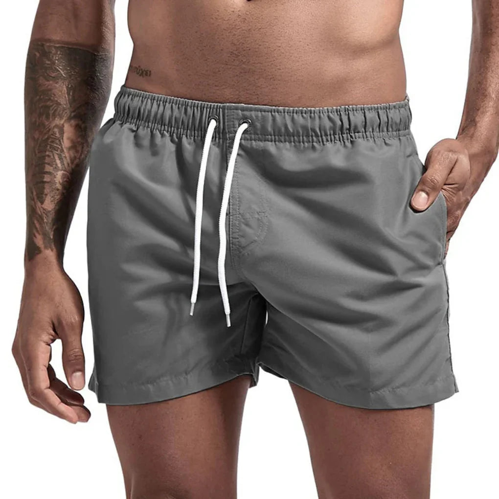Essential men's quick-dry swim shorts for tropical beach vacations & comfort.