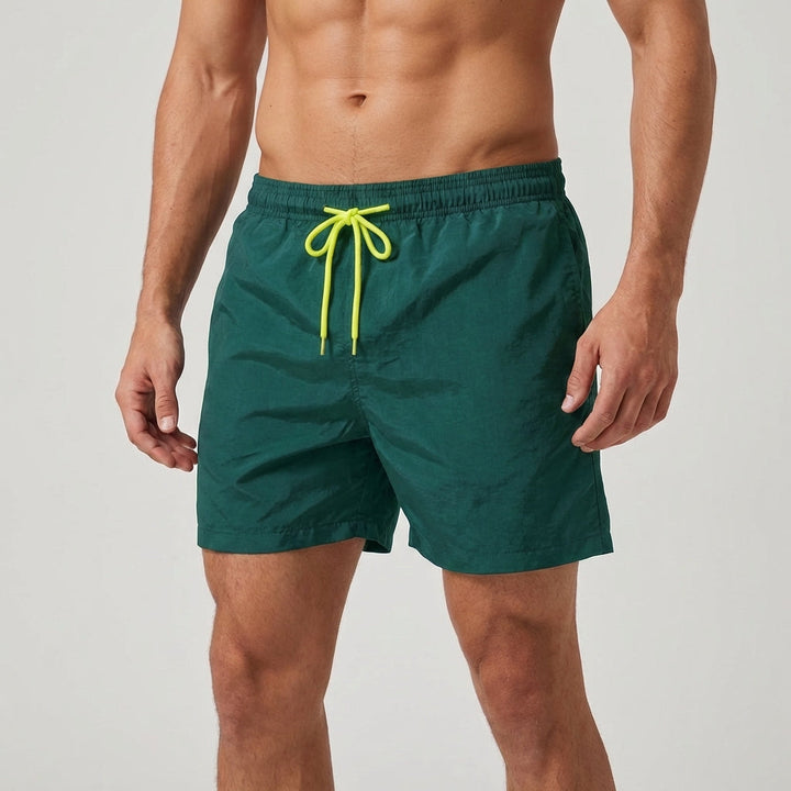 Solid color men's quick-dry swim shorts, elastic waist, great for tropical vacations.
