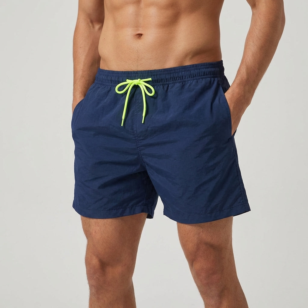 Stylish men's quick-dry swim trunks, elastic waist, ideal for summer pool wear & vacations.