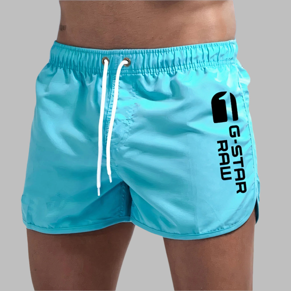 Men's quick dry swim trunks in vibrant blue, perfect for beach and pool.