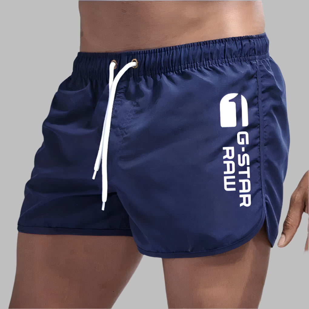 Athletic men's quick dry swim trunks, ideal for swimming and beach activities.