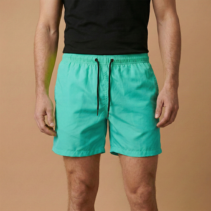 Relaxed fit men's quickdry shorts with an adjustable drawstring, perfect for lounge or sport.