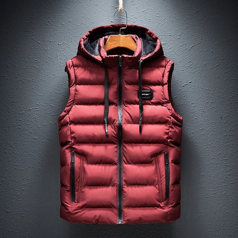 Man wearing a sporty style men's quilted vest with a hood outdoors.