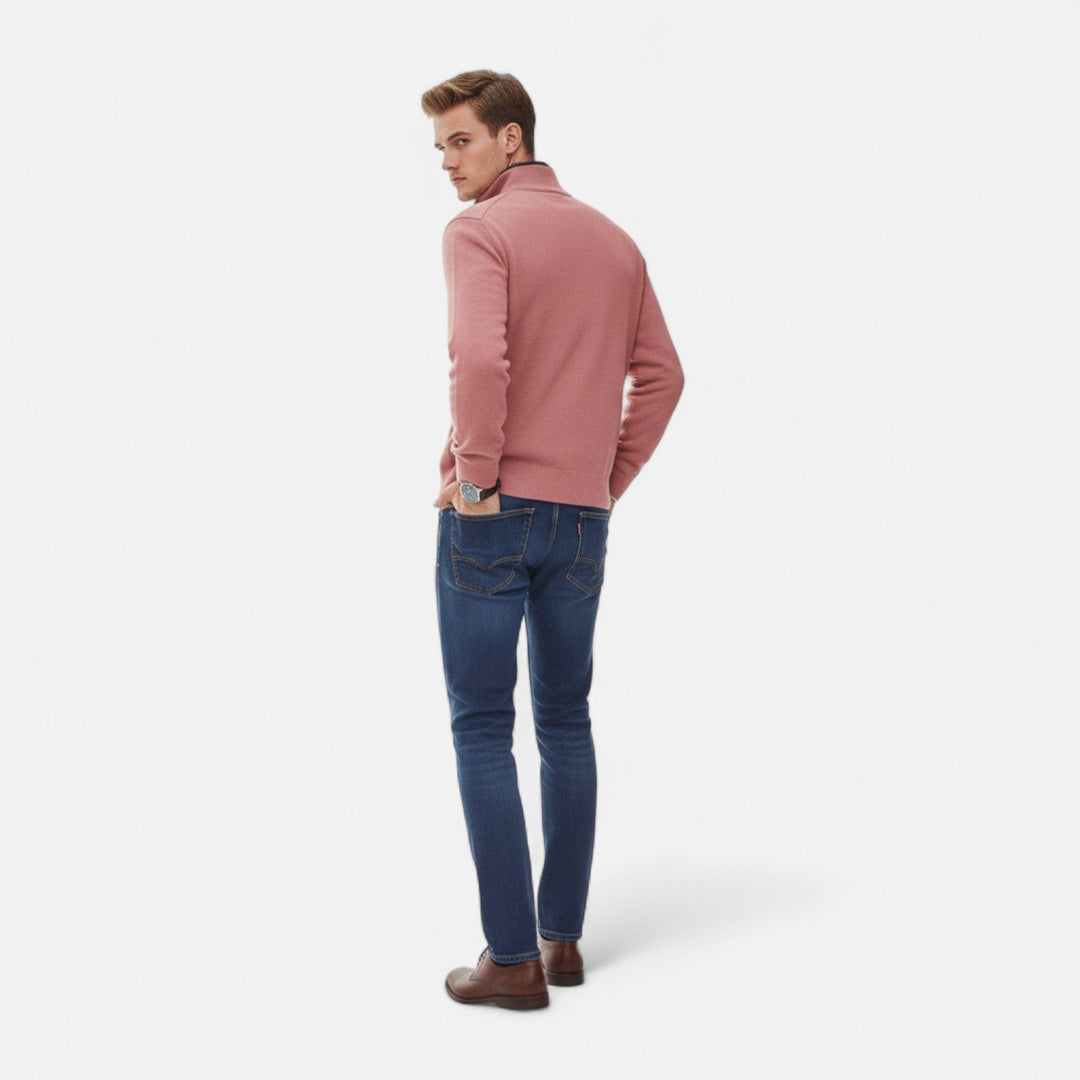 Man wearing a navy blue men's zipper knit sweater, showcasing its layering versatility.