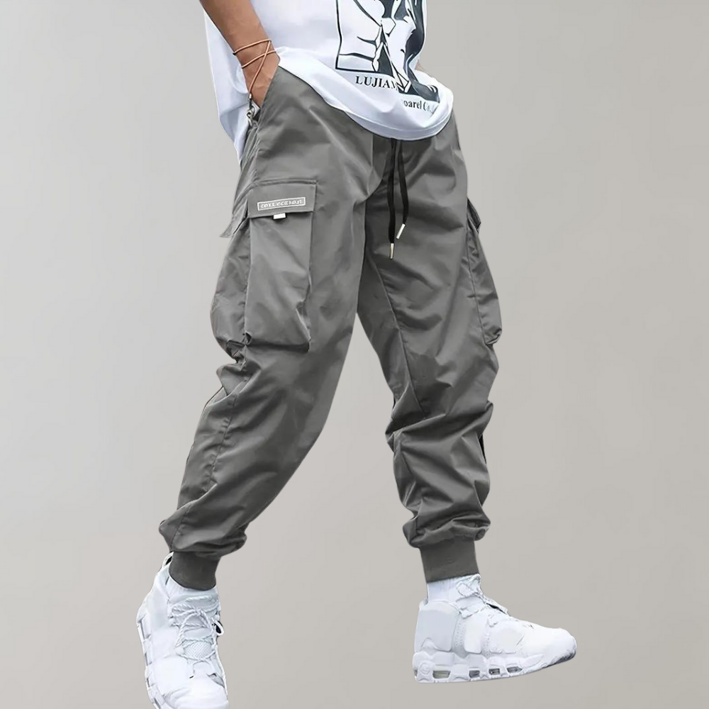 Durable and breathable men's black cargo pants with a modern streetwear aesthetic and drawstring waist.