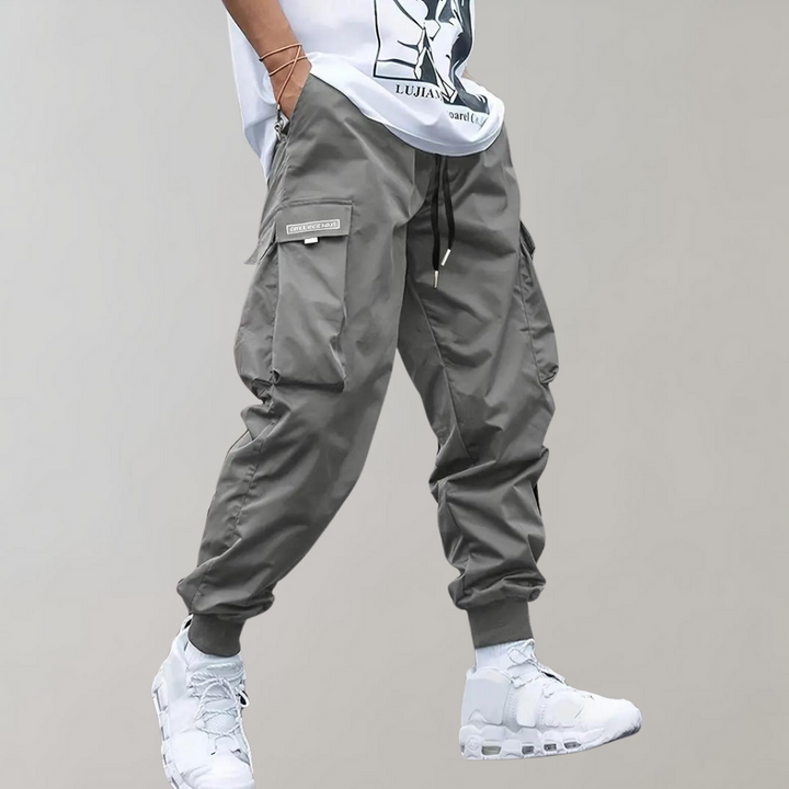 Durable and breathable men's black cargo pants with a modern streetwear aesthetic and drawstring waist.