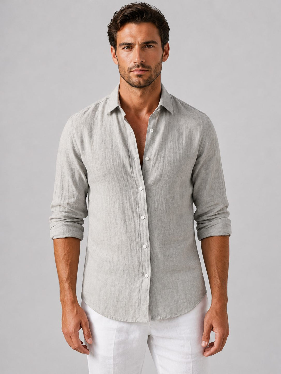 Man wearing a relaxed fit long sleeve button-up shirt, styled casually for summer.
