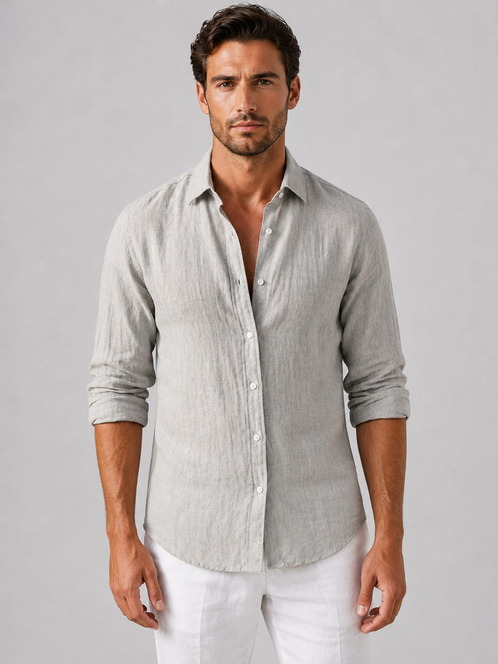 Man wearing a relaxed fit long sleeve button-up shirt, styled casually for summer.