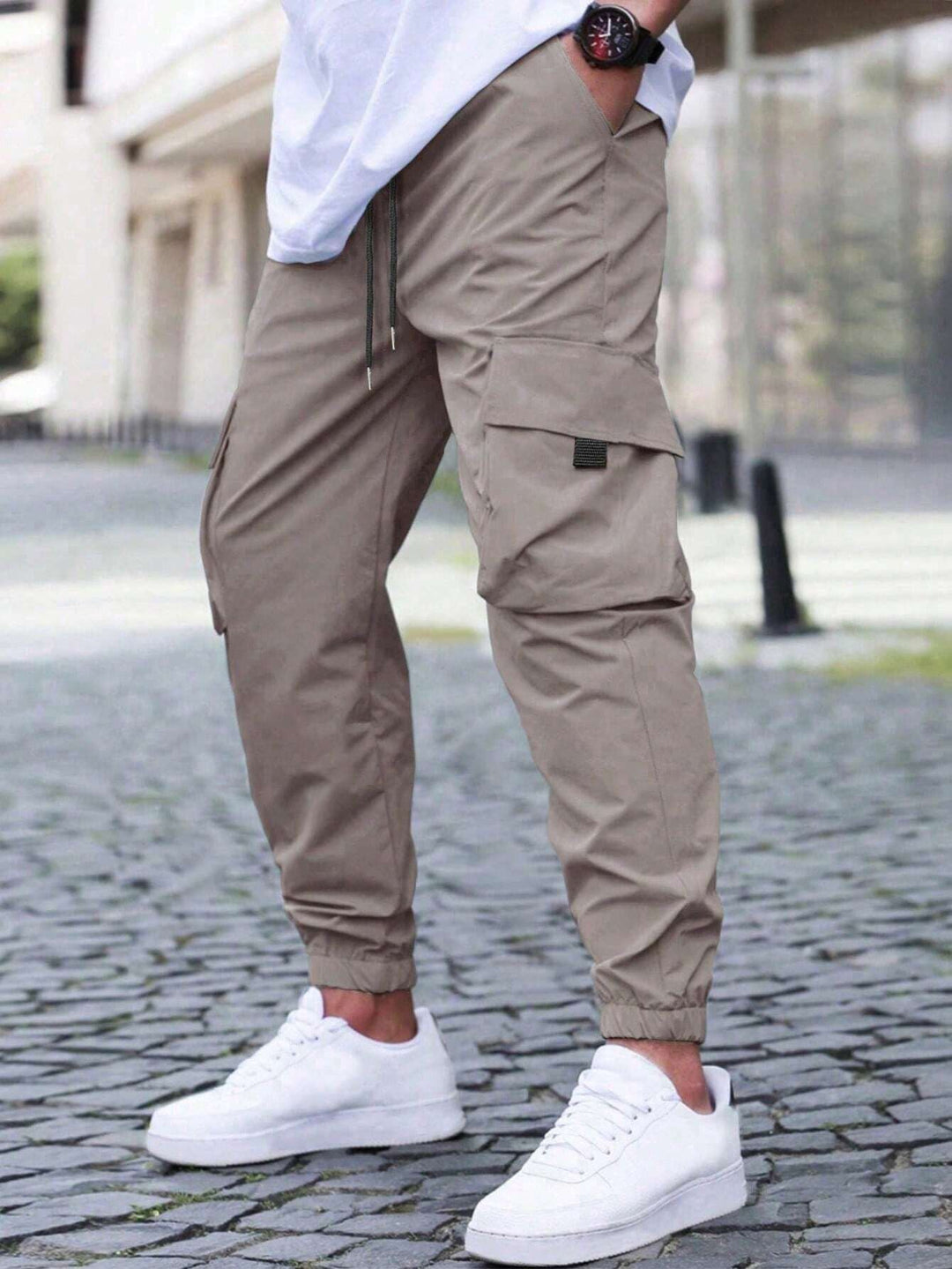 Close-up of men's utility cargo joggers showing pockets & relaxed fit. Ideal men's pants for comfort & style.