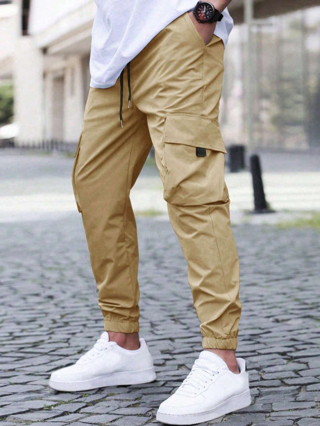 Model wearing men's relaxed fit utility cargo joggers, showcasing casual style & comfort. Men's everyday pants.