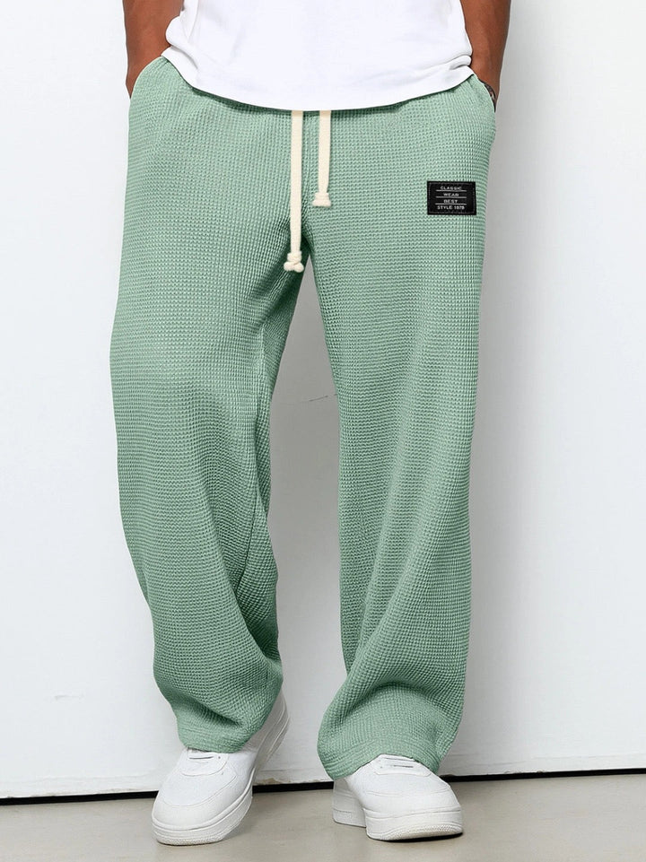 Relaxed fit men's trousers with adjustable waist, breathable fabric for all-day comfort.