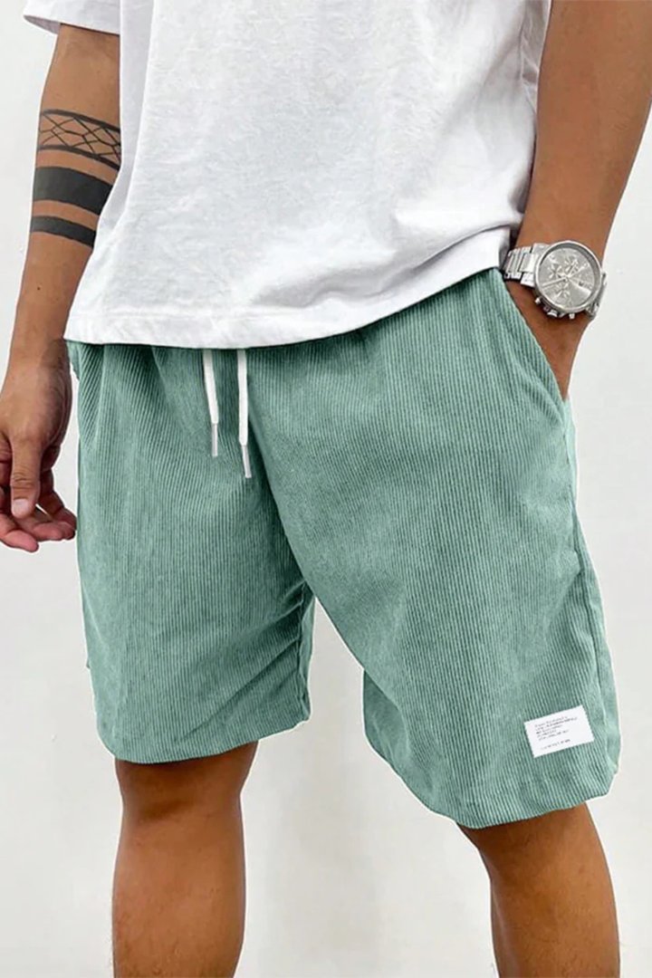 Black men's relaxed fit corduroy shorts, perfect for casual outings and beach days.