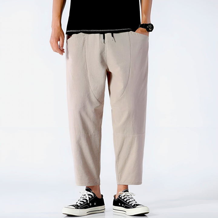 Side pocket detail of men's relaxed fit cropped chinos, combining practical design with stylish casual wear.