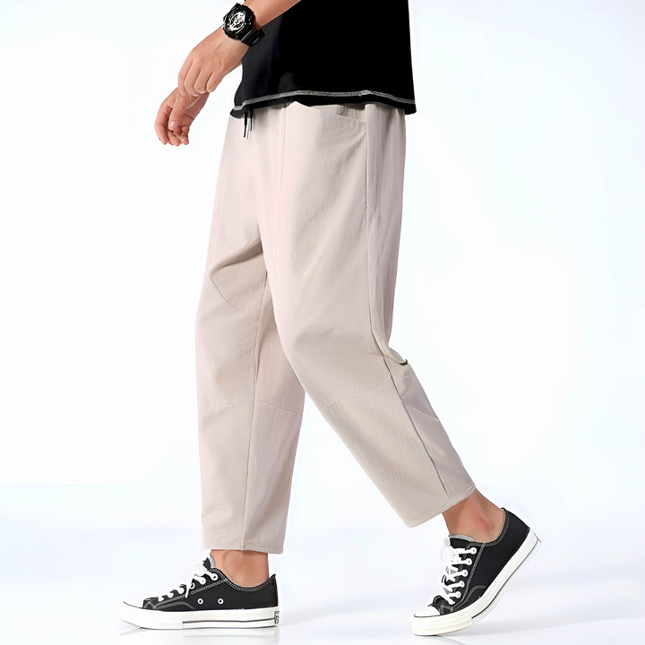 Assortment of men's relaxed fit cropped chinos in multiple colors, offering versatile summer style options.