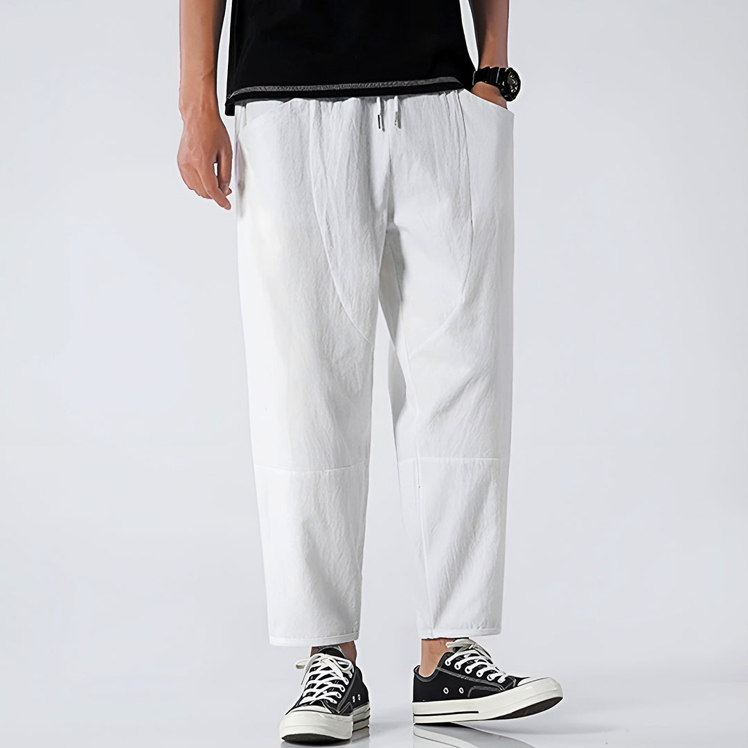 Drawstring waistband of men's relaxed fit cropped chinos, offering adjustable comfort & modern casual style.
