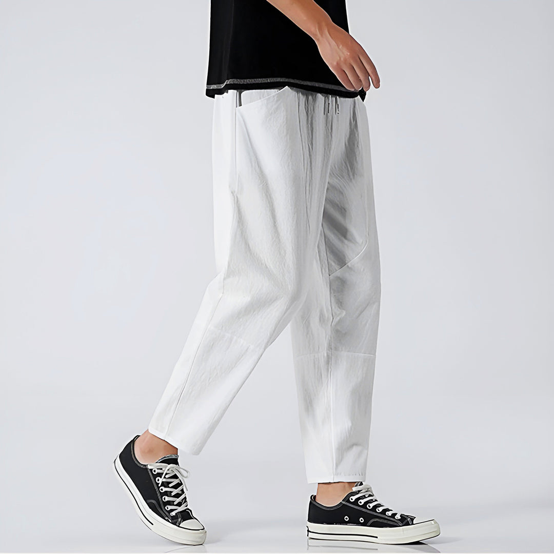 Model wearing men's stylish relaxed fit cropped chinos, showcasing a fashionable and comfortable summer look.