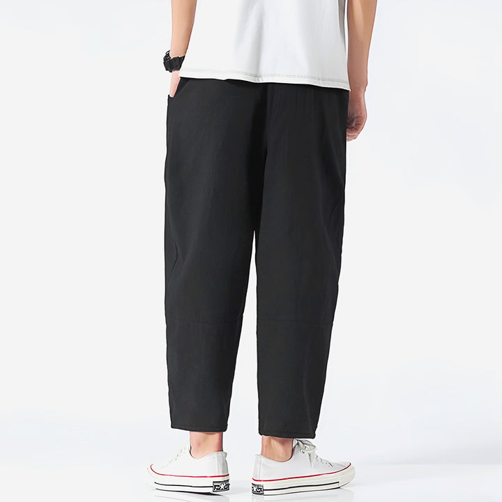 Folded men's relaxed fit cropped chinos, highlighting the product's quality and easy-to-wear casual style.