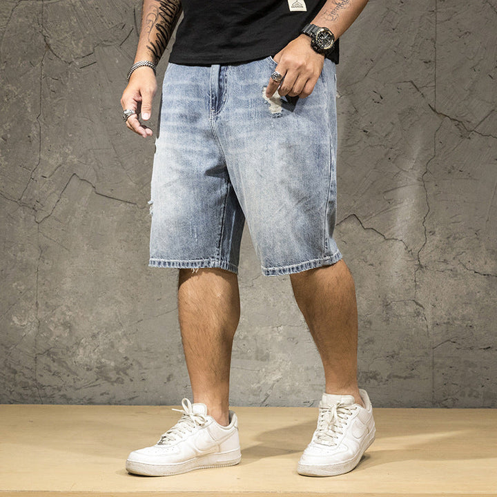 Men's relaxed fit distressed denim shorts with ripped details, perfect for casual summer street style.