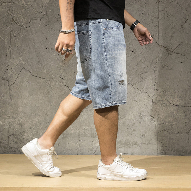 Trendy men's distressed ripped shorts for a relaxed fit, ideal for modern casual weekend wear.