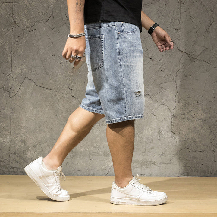 Trendy men's distressed ripped shorts for a relaxed fit, ideal for modern casual weekend wear.