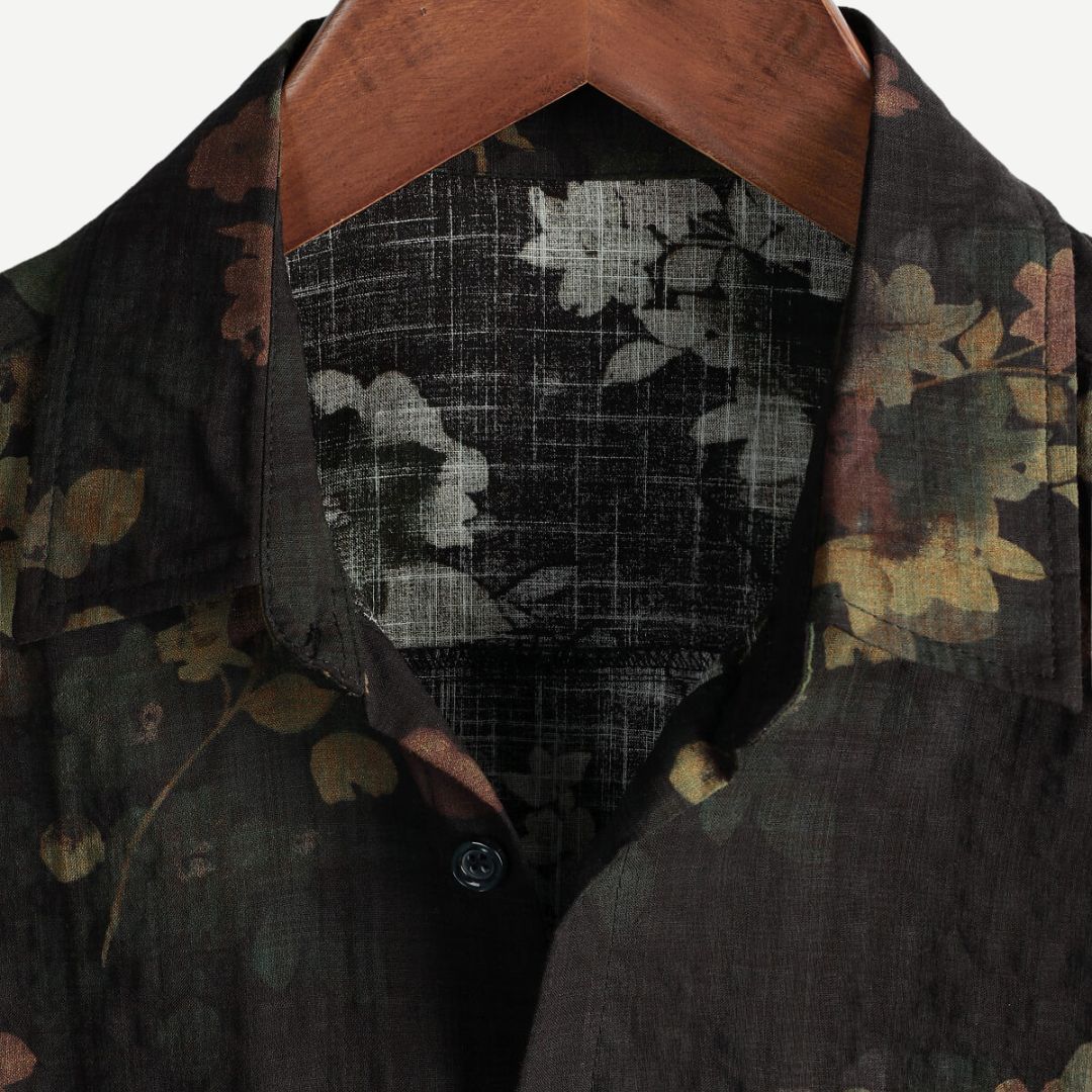 Stylish men's green floral short-sleeve shirt. Relaxed fit, vibrant print, great for casual summer fashion.