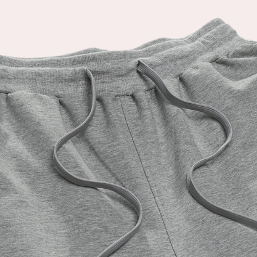 Modern men's relaxed fit sweatpants, solid color, featuring drawstring & elastic waist.