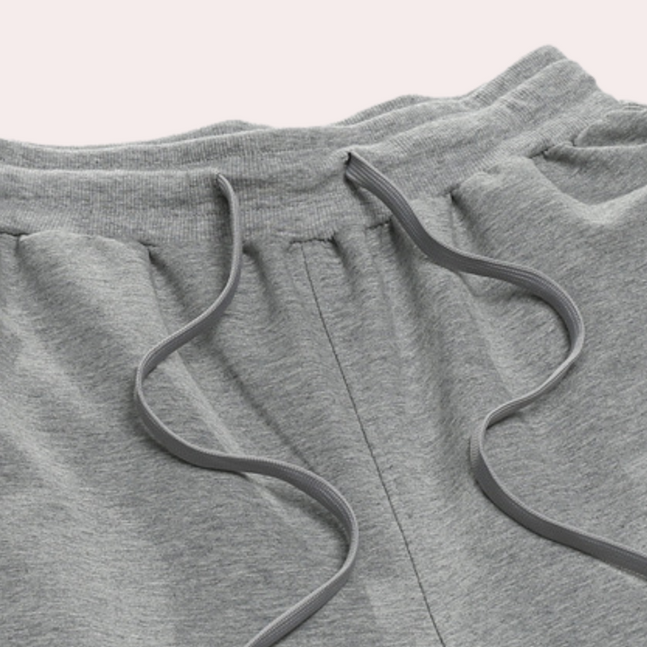 Modern men's relaxed fit sweatpants, solid color, featuring drawstring & elastic waist.