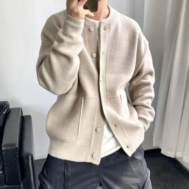 Comfortable men's relaxed fit knit cardigan featuring a round neck, button-up closure, and pockets.