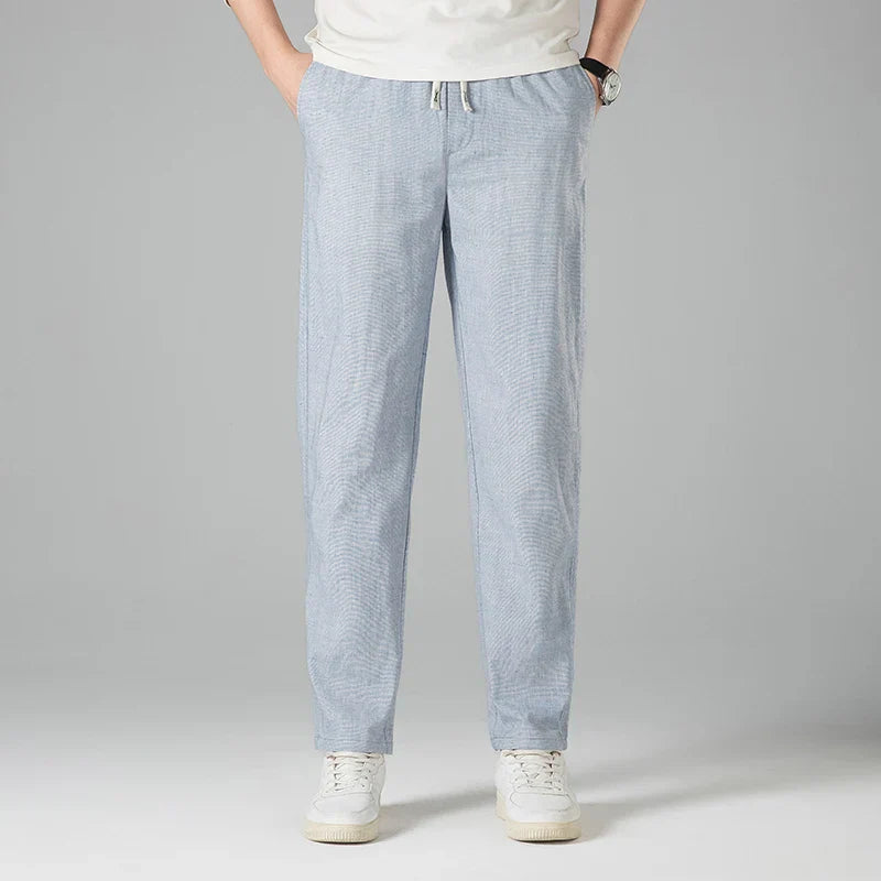 Khaki men's relaxed linen trousers with adjustable drawstring waist, perfect for warm weather comfort.