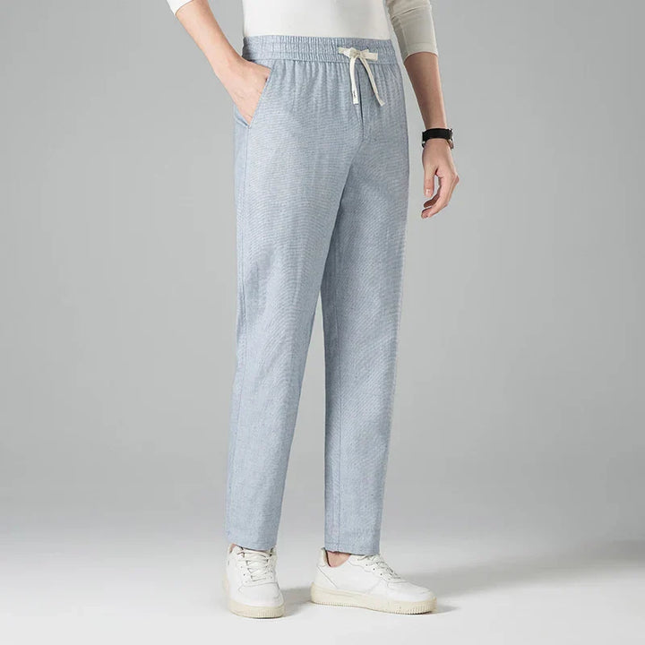 Blue men's casual linen trousers, relaxed fit with a comfy drawstring waist, great for summer.