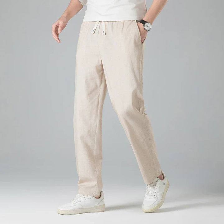 Gray men's relaxed linen pants featuring a drawstring waist, offering casual style and comfort.