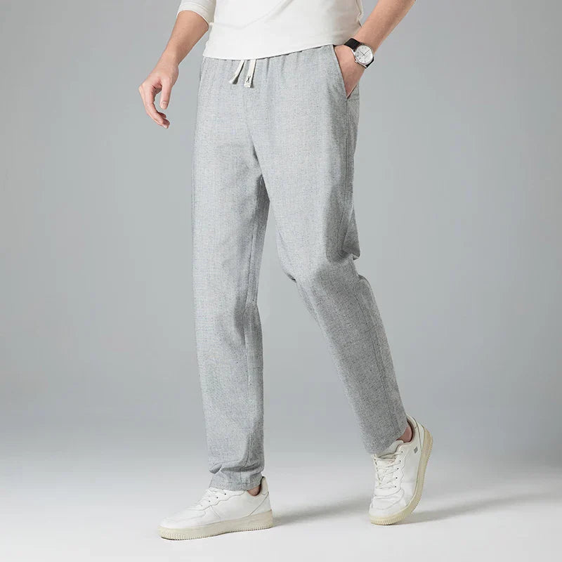 Stylish men's linen trousers, relaxed fit with an elastic drawstring waist for casual summer looks.
