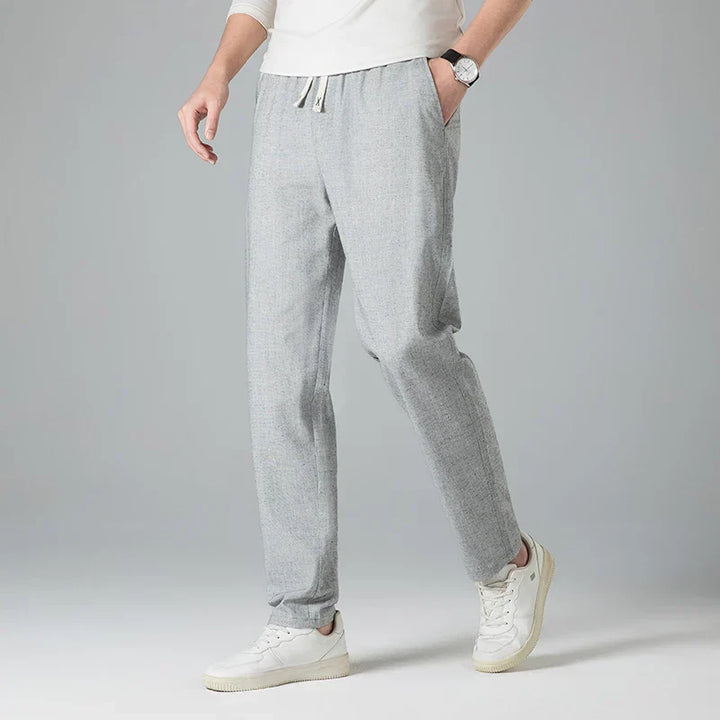 Stylish men's linen trousers, relaxed fit with an elastic drawstring waist for casual summer looks.