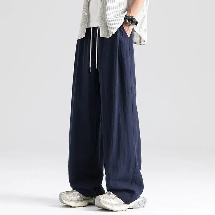 Breathable men's linen wide leg pants with a relaxed fit and drawstring waist for ultimate summer comfort.