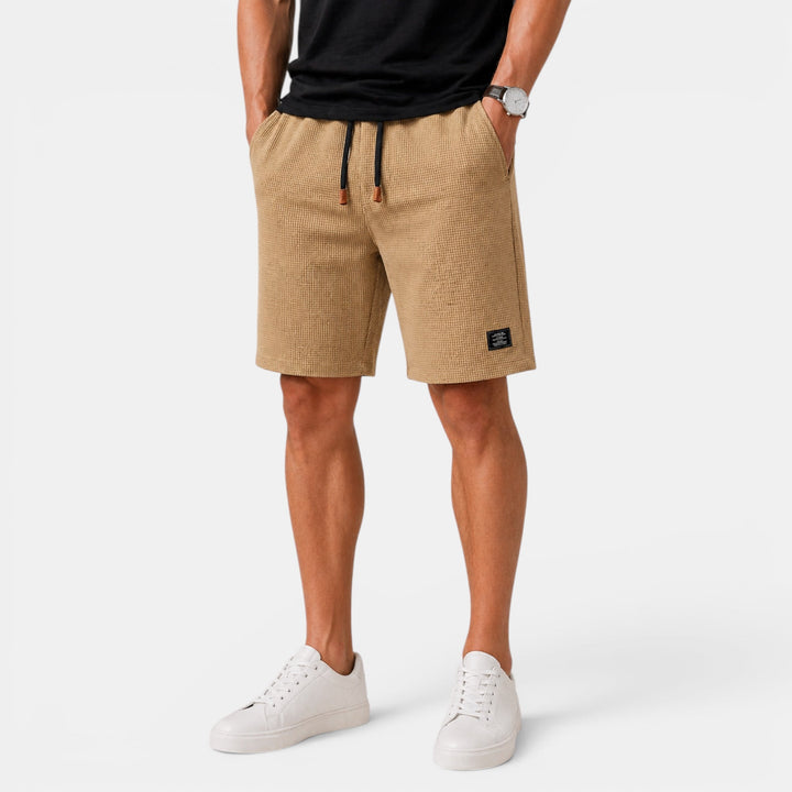Comfortable men's relaxed fit shorts, featuring an elastic waist and pockets for everyday summer wear.