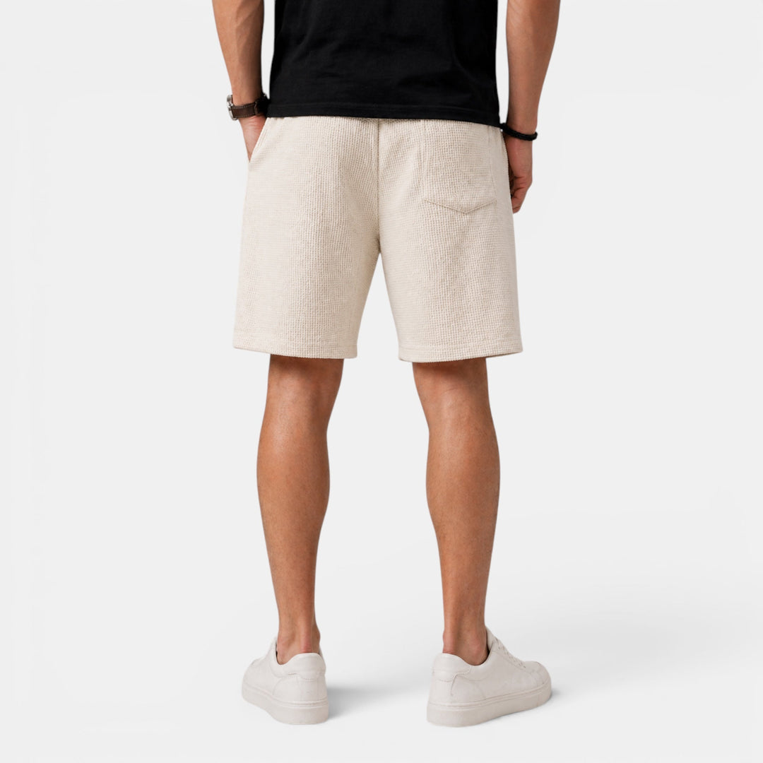 Fashionable men's casual shorts with a relaxed fit and elastic waist, essential for summer comfort.
