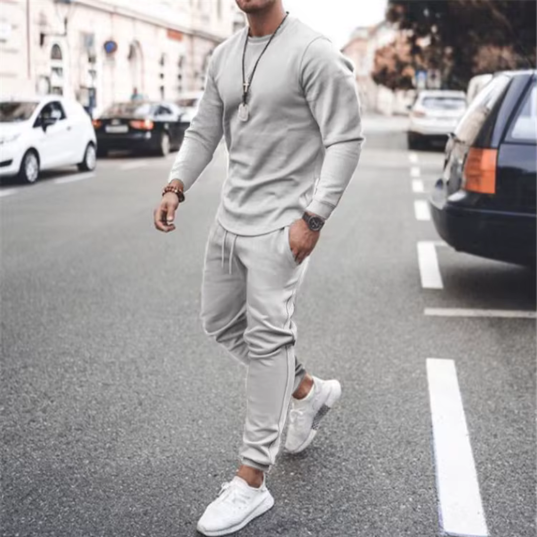 Men's relaxed fit two-piece casual set in a versatile neutral tone. Cotton blend loungewear for comfort.