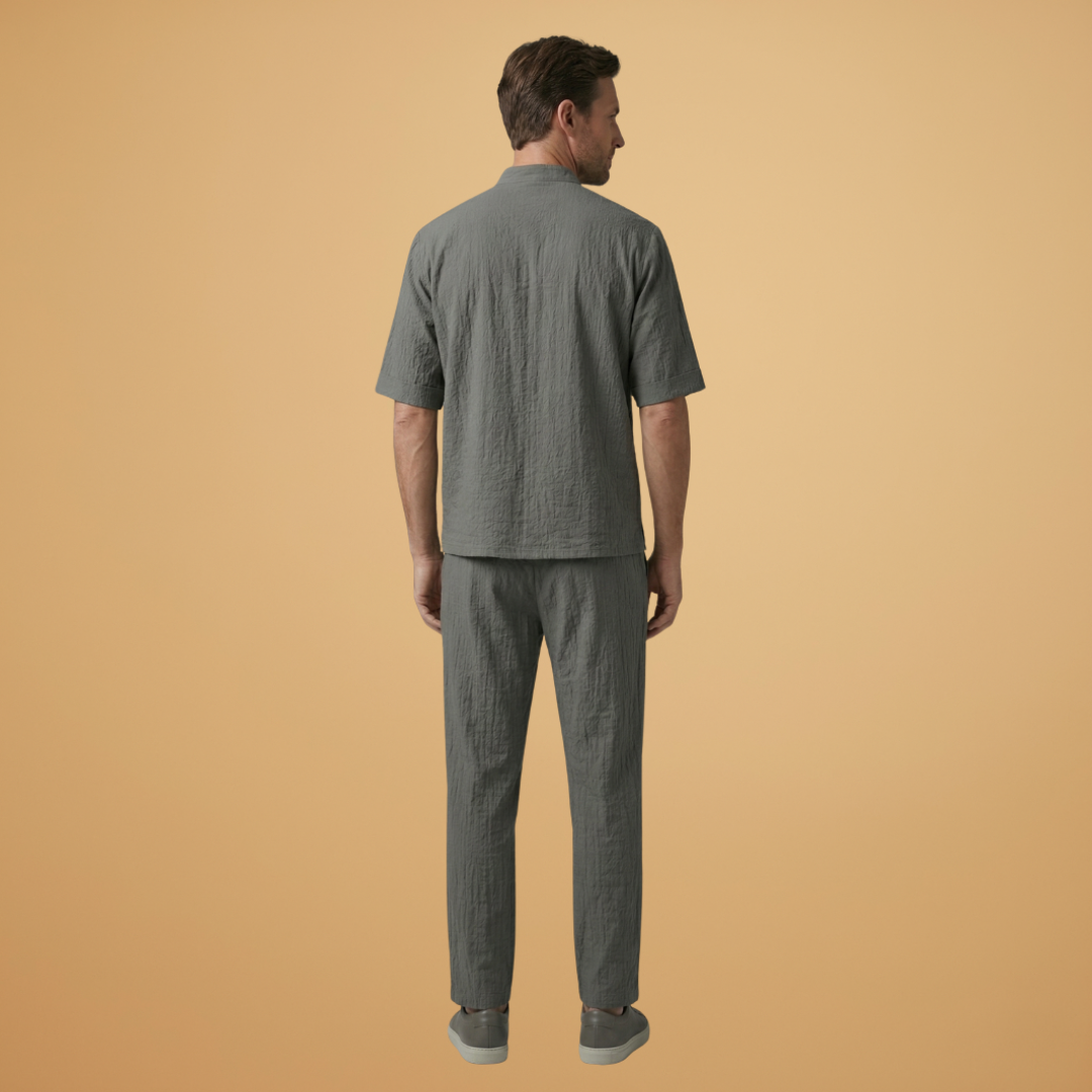 Relaxed fit men's two-piece set with a long sleeve shirt and adjustable drawstring trousers. Versatile style.